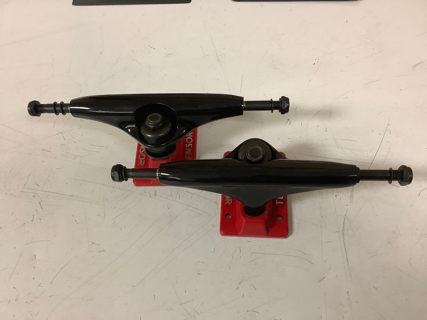 Tensor Trucks 5.5 black hangers with red baseplates