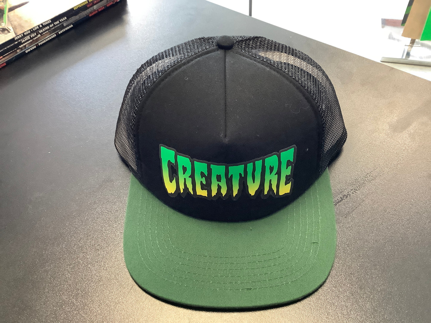 Creature trucker hat green /black